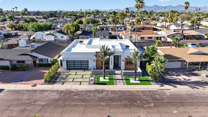 Daytime drone photo of a modern home and street